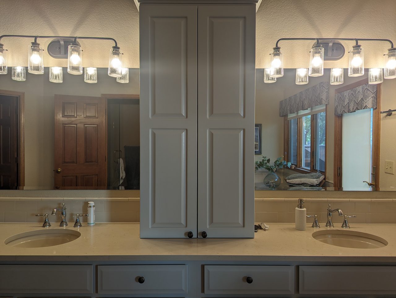 Dark wood kitchen cabinetry under warm pendant lighting