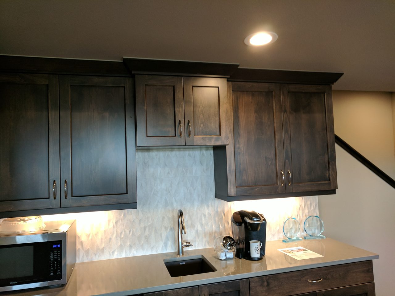 A finished modern kitchen with a dark island