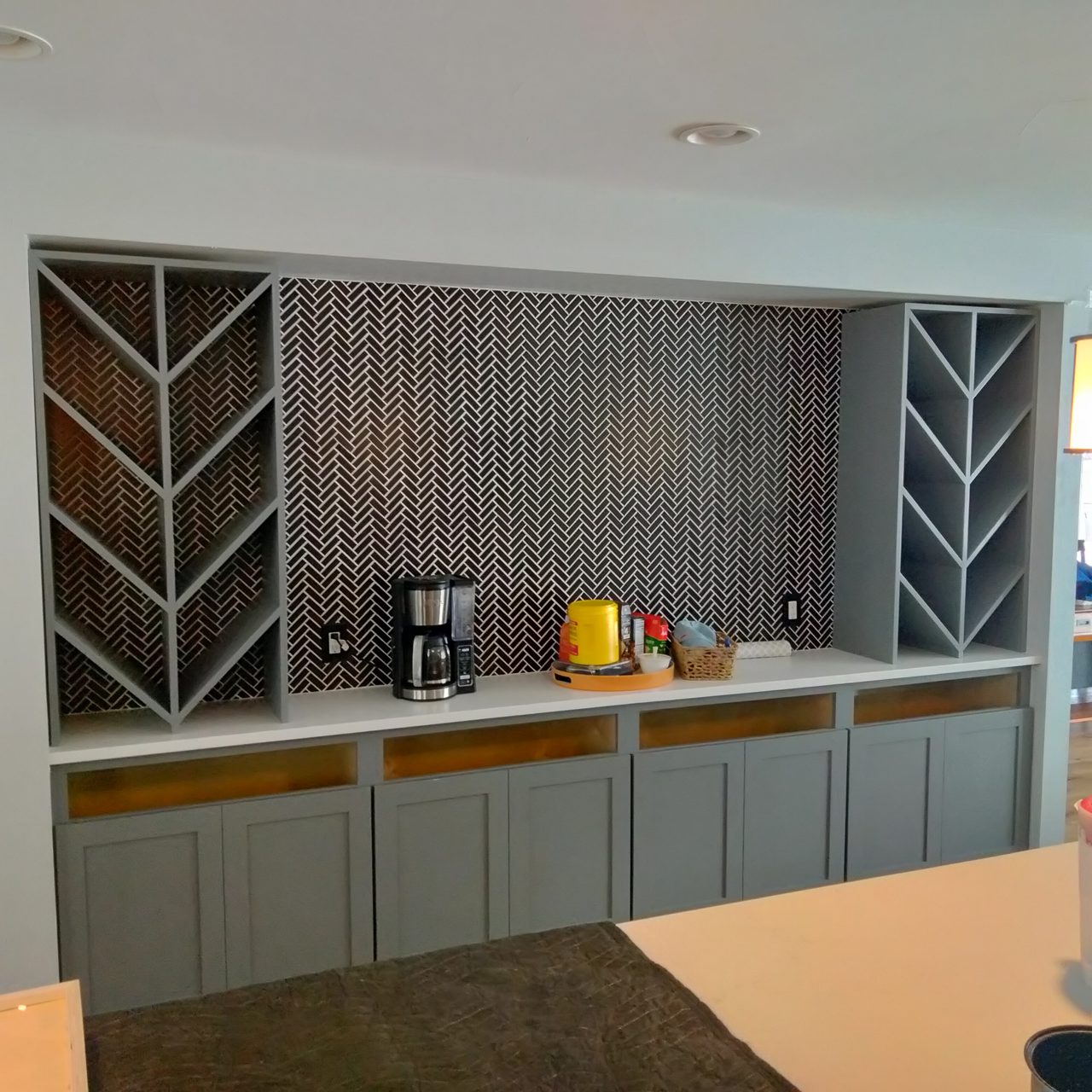 Two-tone kitchen with a herringbone tile backsplash